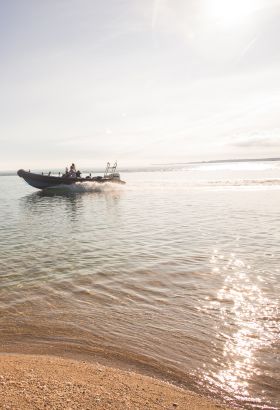 A RIB boat speeding along the sea
